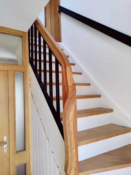 Holztreppe mit schwarzen Geländerstäben in Hofgeismar
